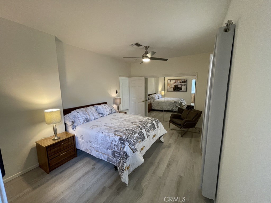 35330 Rosemont Drive Palm Desert, CA 92211 - Photo 19 of 38 a bedroom with a bed and wooden floor