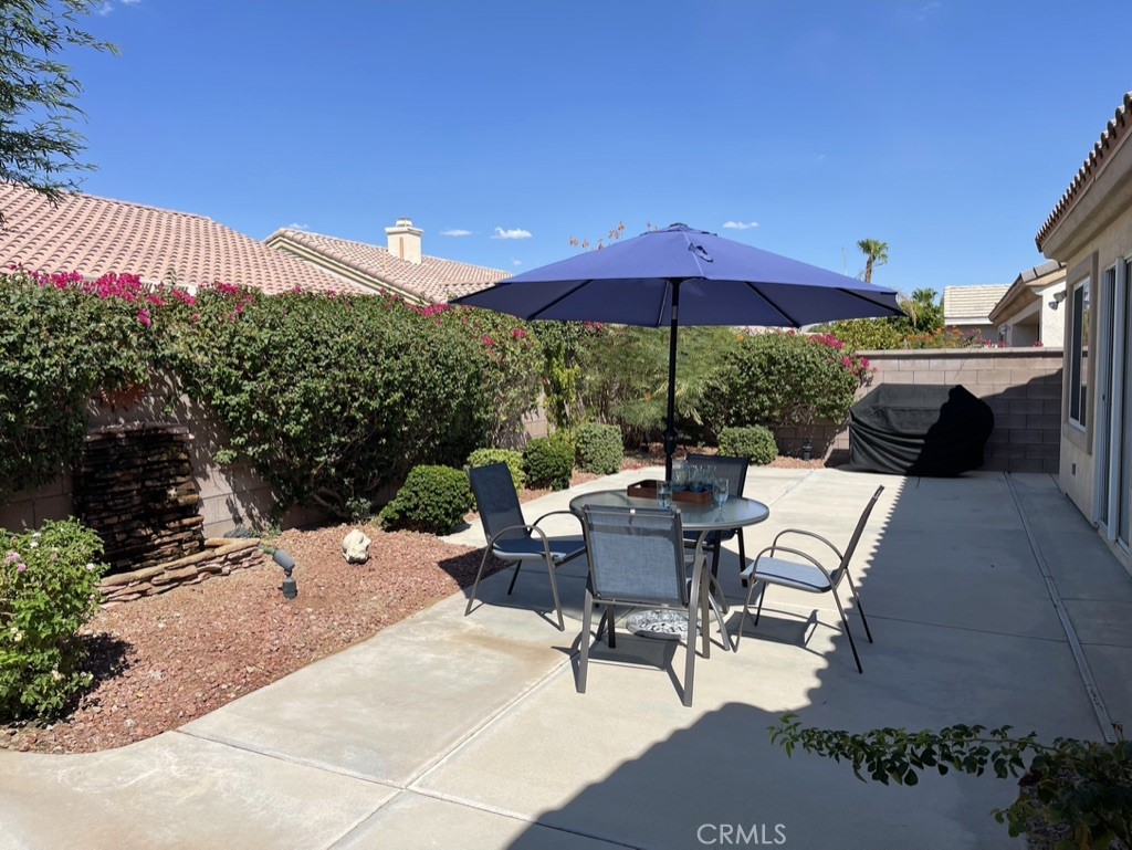 35330 Rosemont Drive Palm Desert, CA 92211 - Photo 21 of 38 a view of a patio with a table and chairs under an umbrella