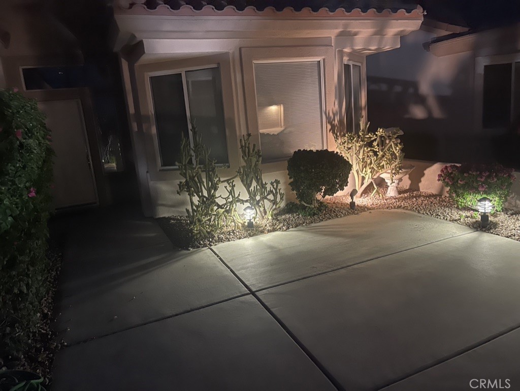 35330 Rosemont Drive Palm Desert, CA 92211 - Photo 26 of 38 a vase of flowers sitting on a floor in front of a house