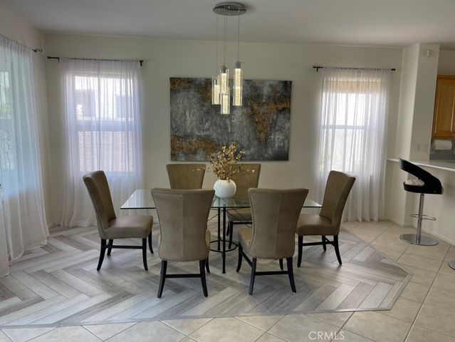 a view of a dining room with furniture and chandelier
