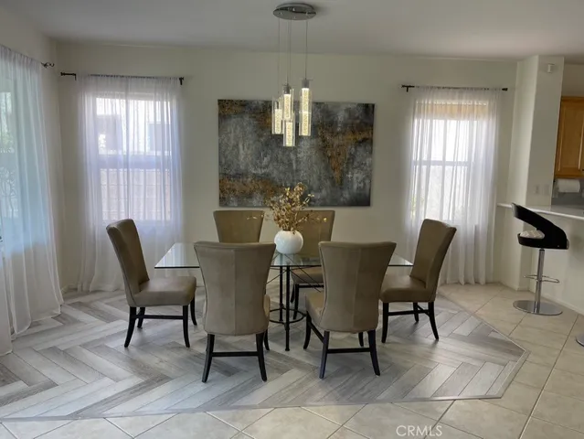 a view of a dining room with furniture and chandelier