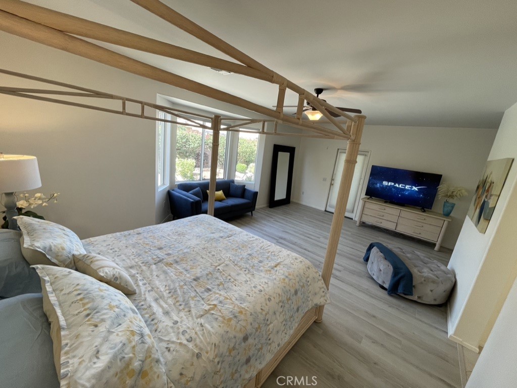 35330 Rosemont Drive Palm Desert, CA 92211 - Photo 10 of 38 a bedroom with a bed and a chandelier