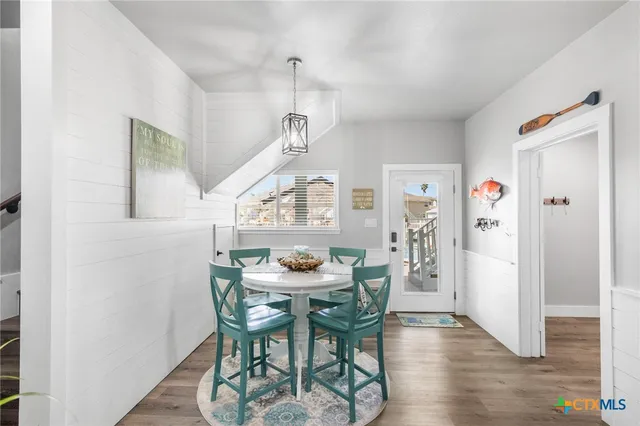 a view of a dining room with furniture and wooden floor