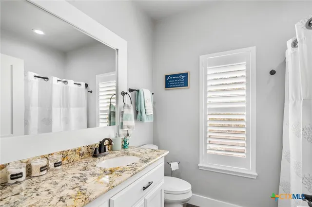 a spacious bathroom with a double vanity sink a mirror and a bathtub