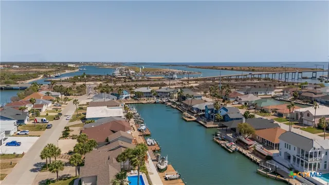 a view of a swimming pool with a yard and seating area