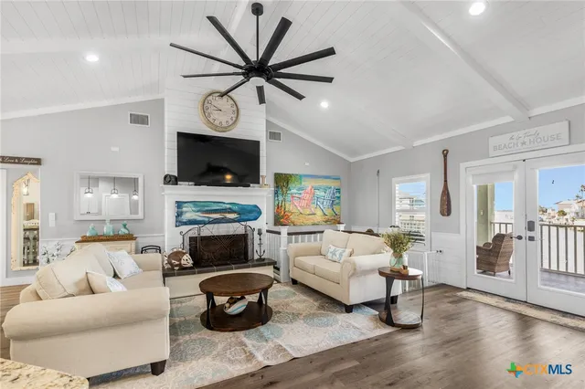 a living room with fireplace furniture and a flat screen tv
