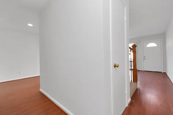 a view of a hallway with wooden floor