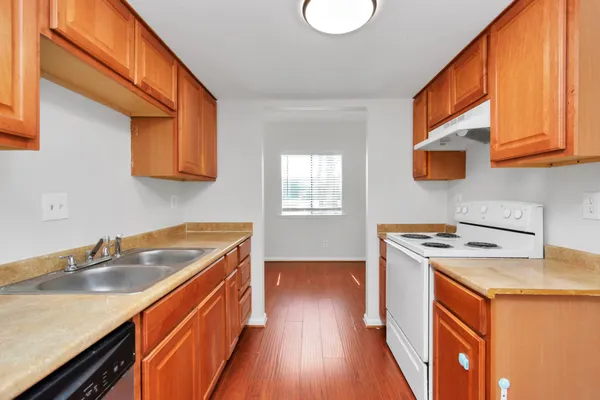 a kitchen with stainless steel appliances granite countertop a sink stove and cabinets