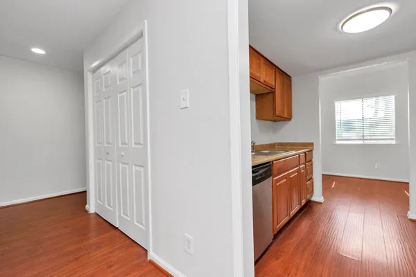 a view of a hallway with wooden floor and staircase