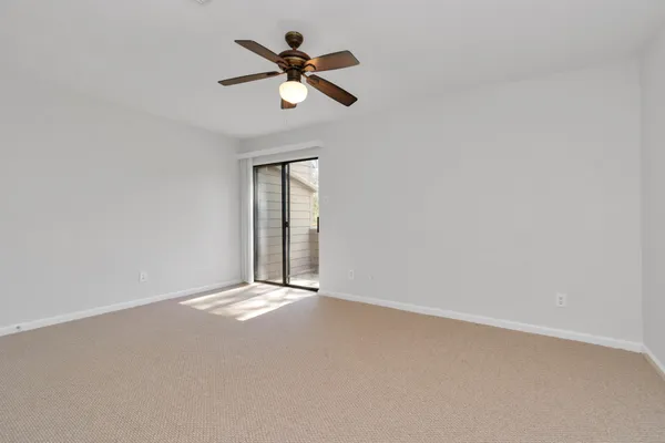 a view of empty room with ceiling fan
