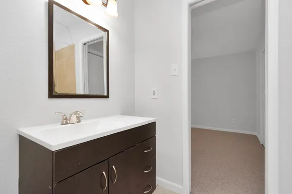 a bathroom with a sink and a mirror