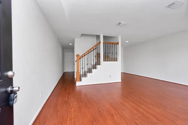 a view of a hallway with wooden floor