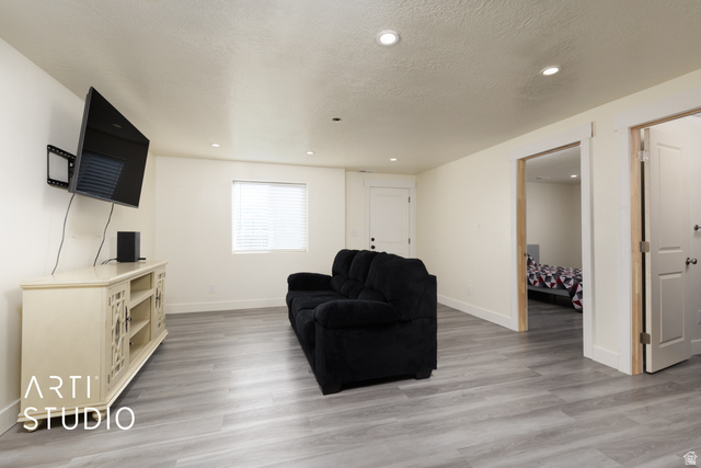 1713 South Windemere Road Santaquin, UT 84655 - Photo 24 of 40 Spacious living area featuring wood-finish flooring, recessed lighting, and a window with blinds