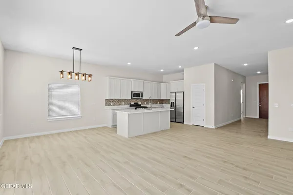 a view of kitchen with refrigerator sink and cabinets