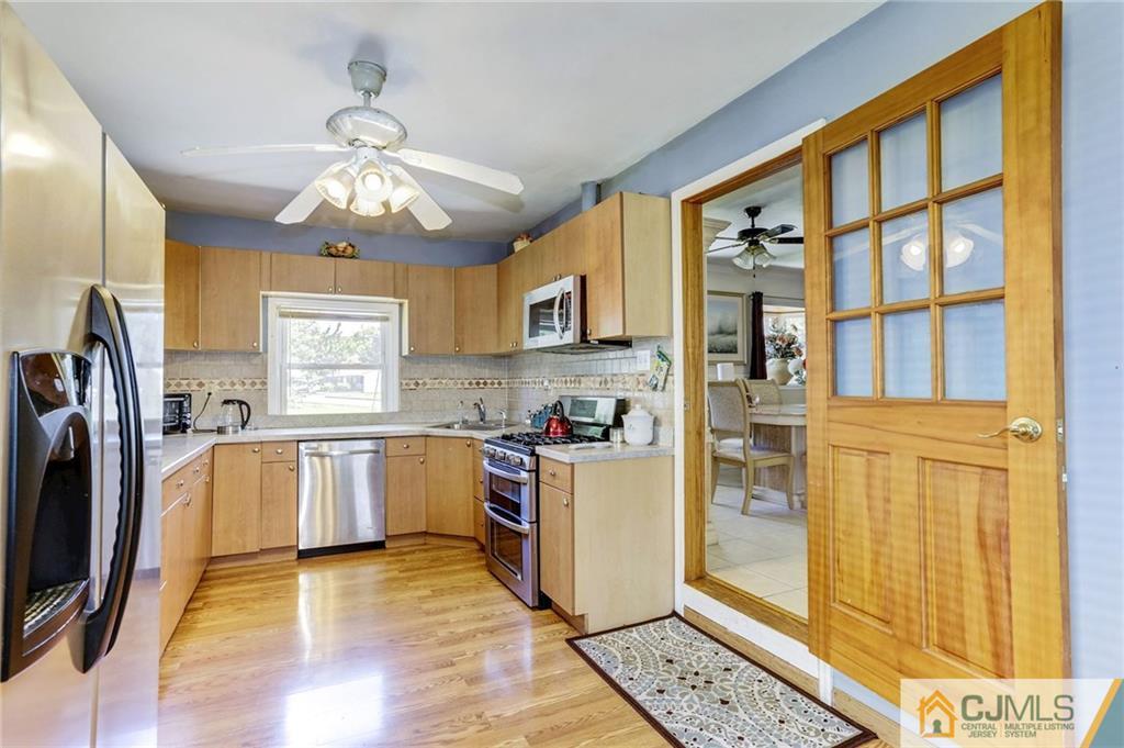 35 Clemson Road Old Bridge, NJ 08859 - Photo 12 of 25 a kitchen with stainless steel appliances granite countertop a refrigerator and a stove top oven
