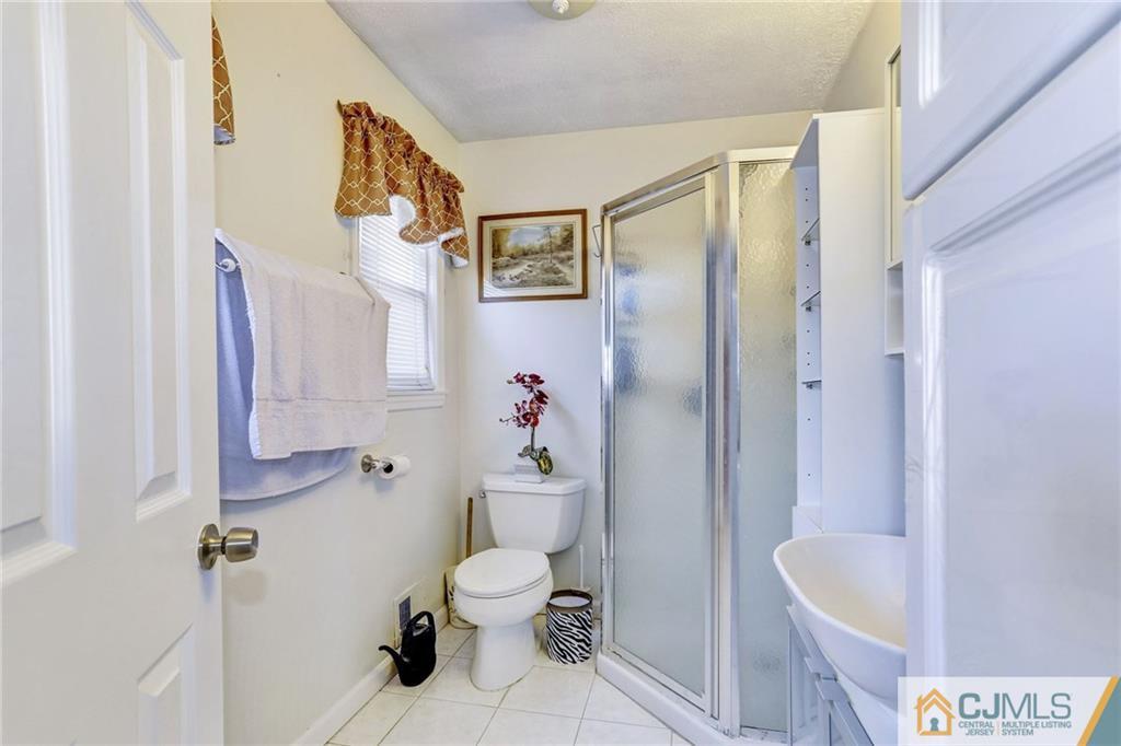 35 Clemson Road Old Bridge, NJ 08859 - Photo 17 of 25 a bathroom with a sink a toilet and shower