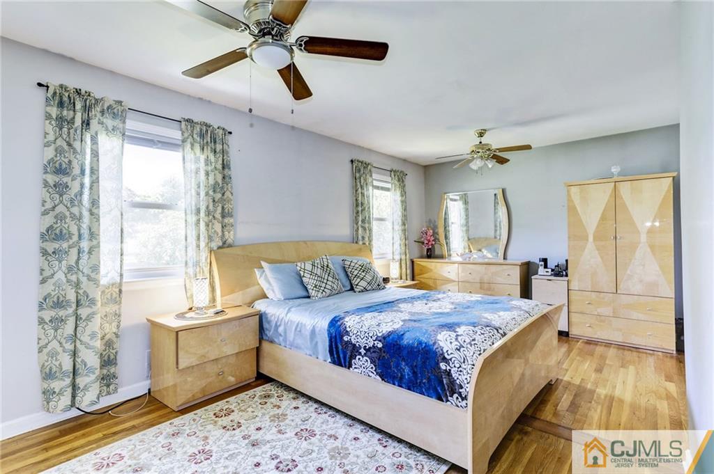 35 Clemson Road Old Bridge, NJ 08859 - Photo 18 of 25 a bedroom with a large bed and a chandelier