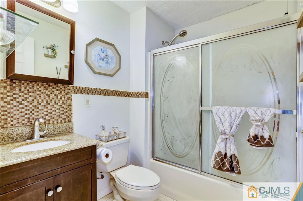 35 Clemson Road Old Bridge, NJ 08859 - Photo 19 of 25 a bathroom with a toilet a sink and a shower
