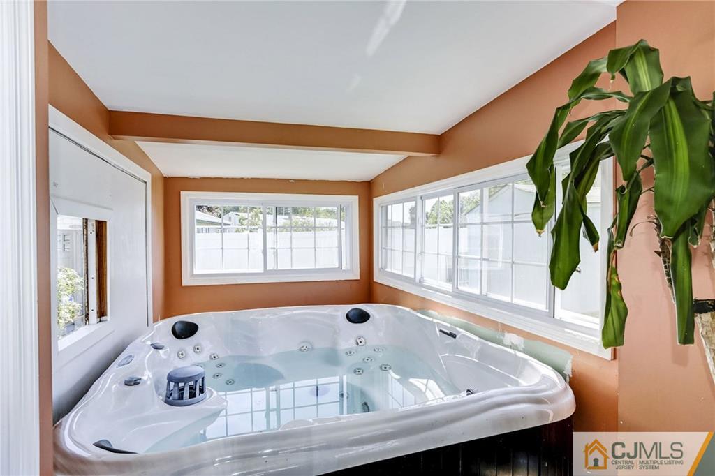 35 Clemson Road Old Bridge, NJ 08859 - Photo 22 of 25 a bath tub sitting in a bathroom next to a window
