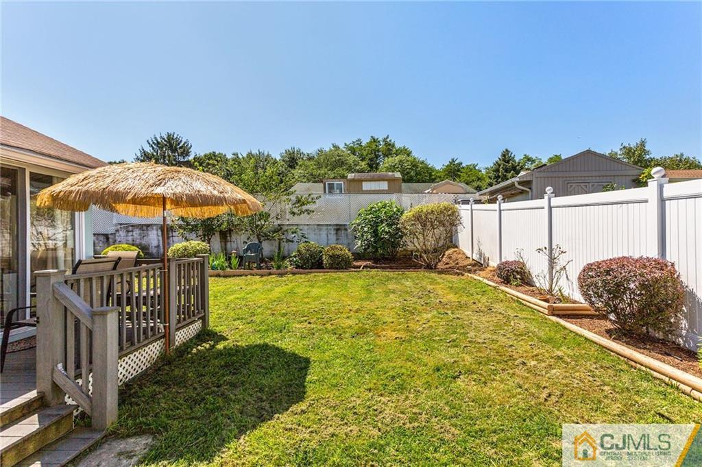 35 Clemson Road Old Bridge, NJ 08859 - Photo 23 of 25 a view of a patio with a table and chairs under an umbrella