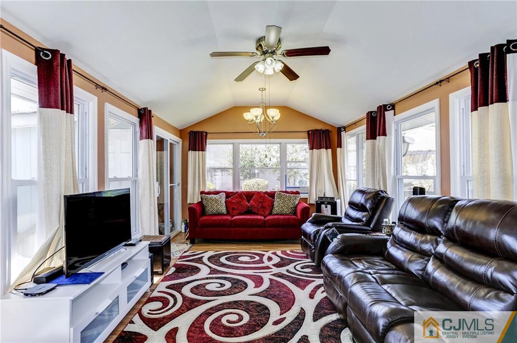 35 Clemson Road Old Bridge, NJ 08859 - Photo 7 of 25 a living room with furniture a flat screen tv and a window