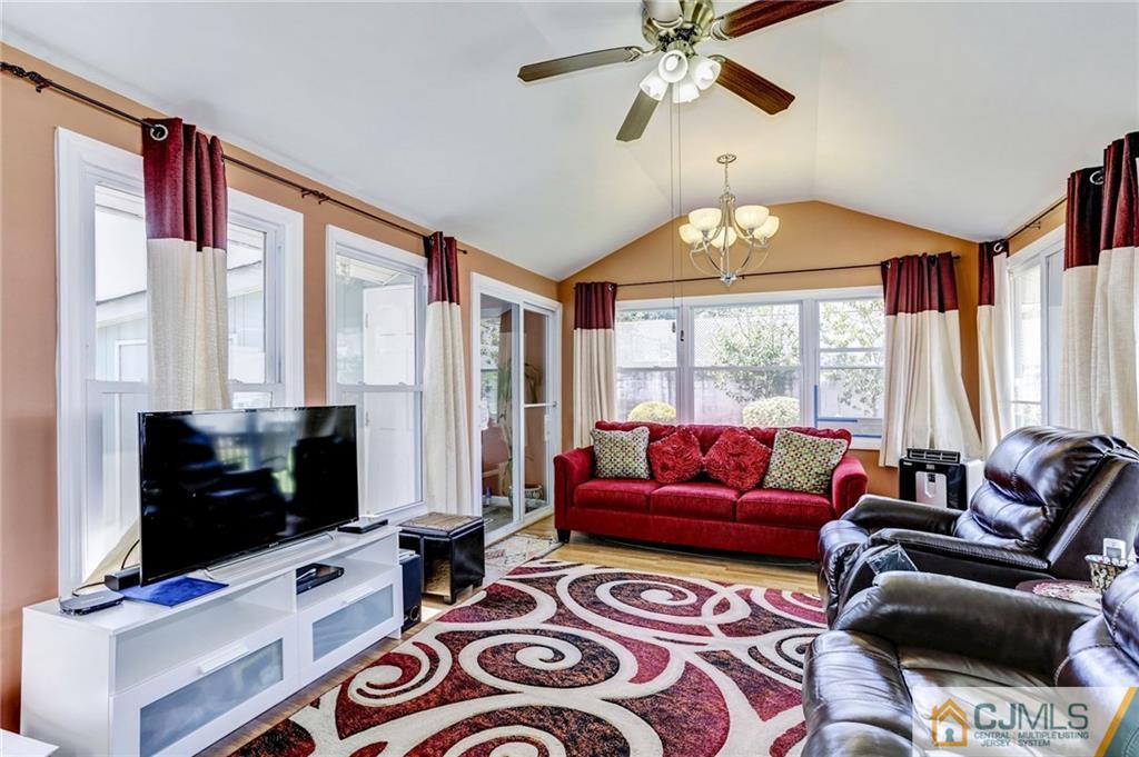35 Clemson Road Old Bridge, NJ 08859 - Photo 8 of 25 a living room with furniture a flat screen tv and a large window