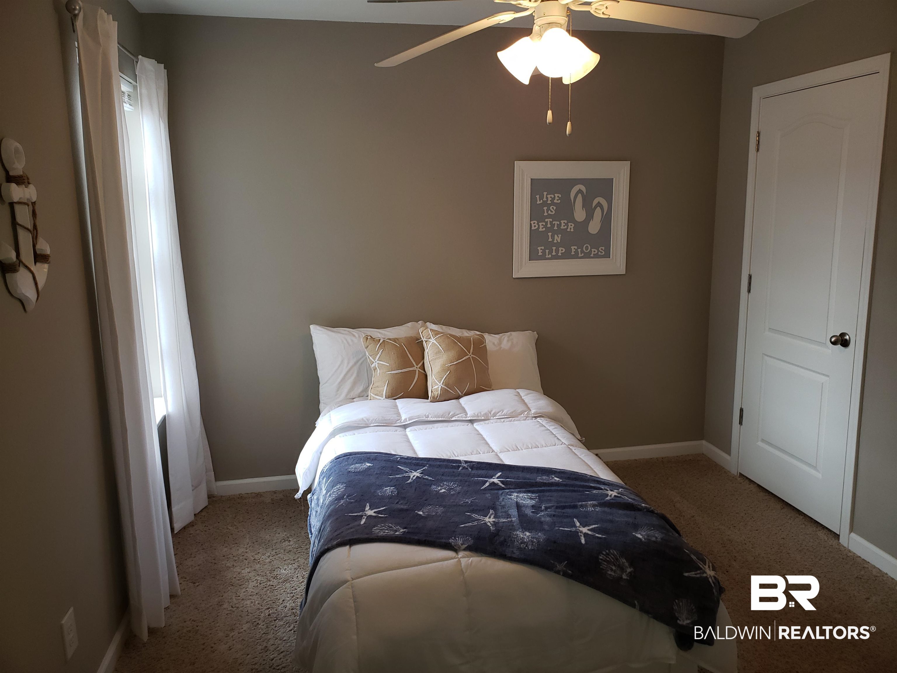 2006 Shelene Way, Unit 2006 Foley, AL 36535 - Photo 14 of 29 Bedroom featuring a ceiling fan, carpet, and baseboards