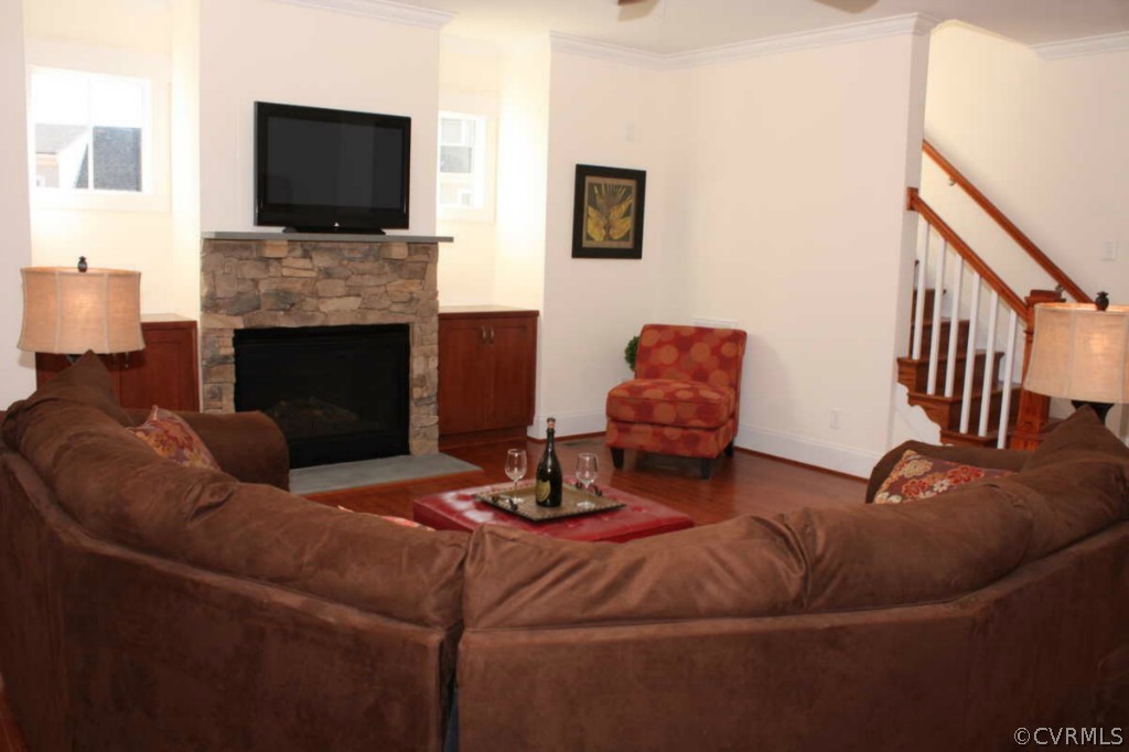 3324 Handley Road Midlothian, VA 23113 - Photo 11 of 24 a living room with furniture a flat screen tv and a fireplace