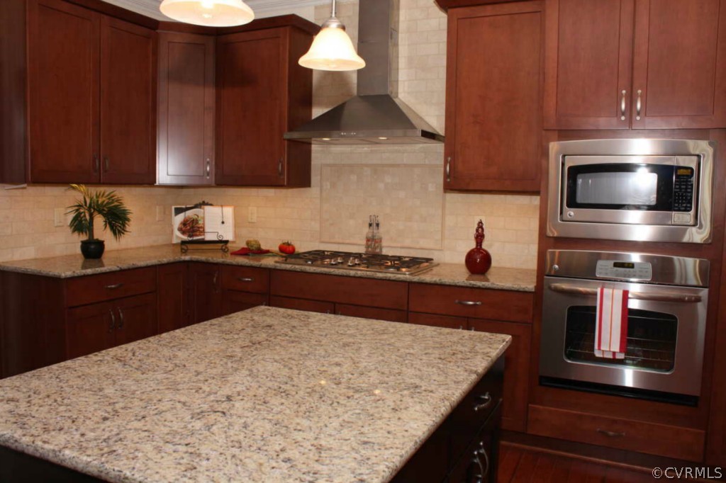 3324 Handley Road Midlothian, VA 23113 - Photo 6 of 24 a kitchen with stainless steel appliances wooden cabinets a stove and a sink