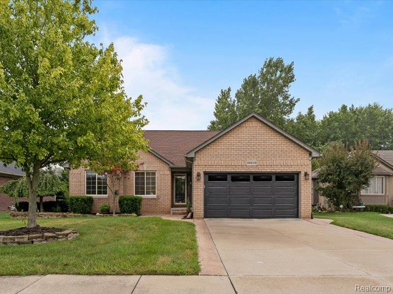 29213 Rachid Lane New Baltimore, MI 48047 - Photo 2 of 26 Ranch-style house with a front yard, driveway, an attached garage, and brick siding