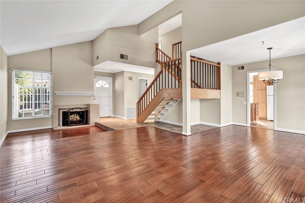 5 Petersburg Irvine, CA 92620 - Photo 2 of 2 Living room with high ceiling and a cozy fireplace.