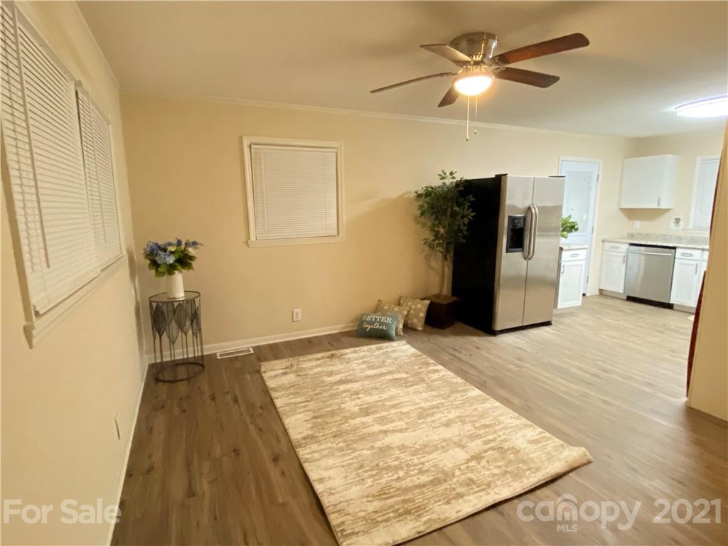 807 Park Road Dallas, NC 28034 - Photo 2 of 8 a view of empty room with wooden floor and fan