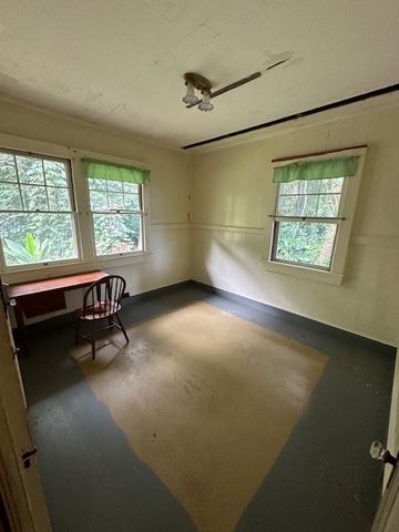 a view of a room with windows and lounge chair