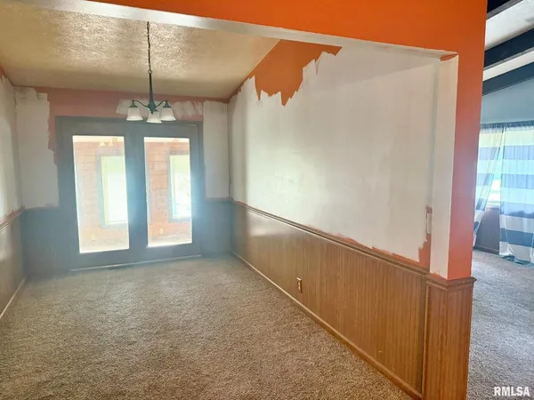 a view of hallway with windows and chandelier