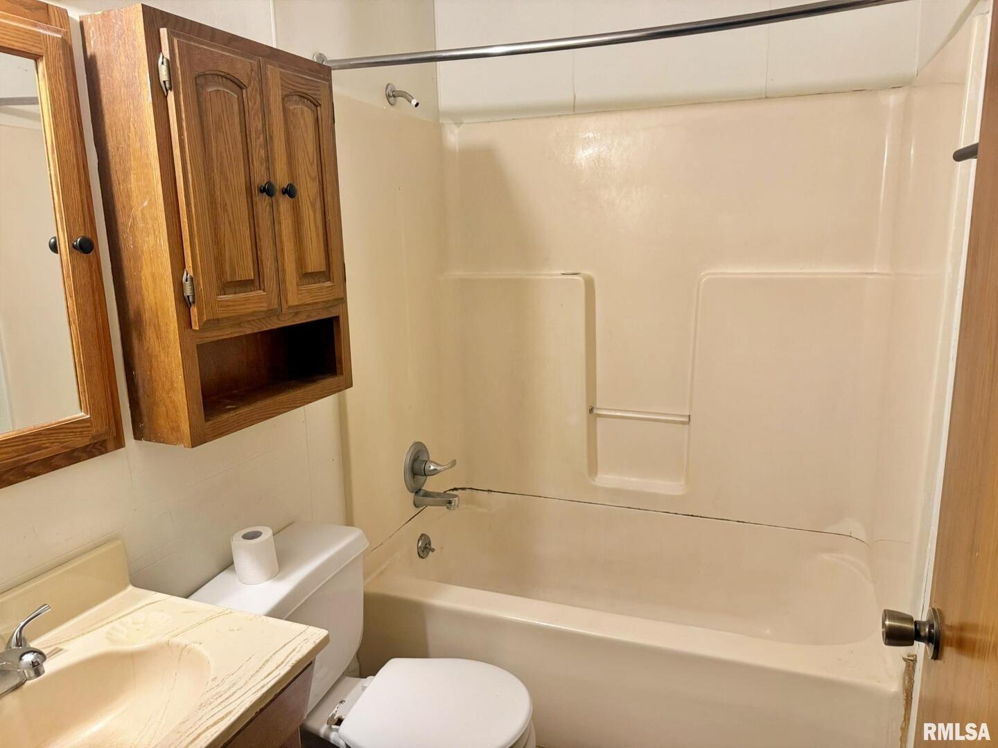 24 Adkins Street Metropolis, IL 62960 - Photo 15 of 23 a bathroom with a shower curtain and a sink