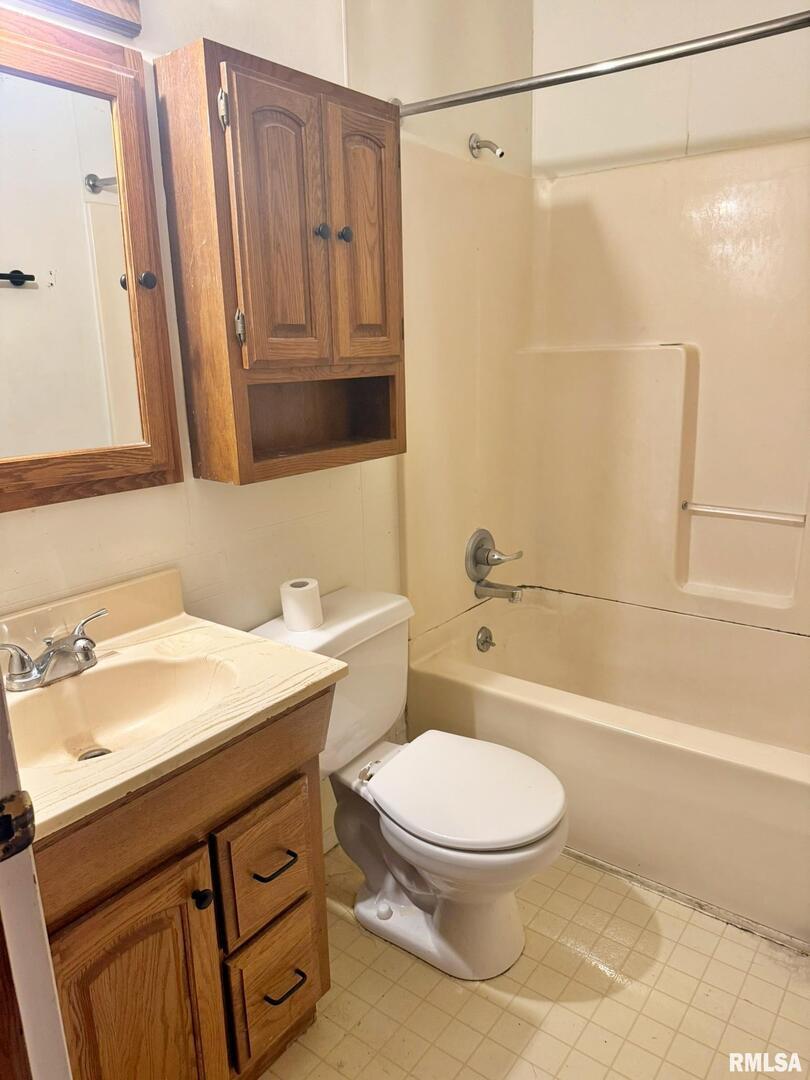 24 Adkins Street Metropolis, IL 62960 - Photo 18 of 23 a bathroom with a sink a toilet and shower