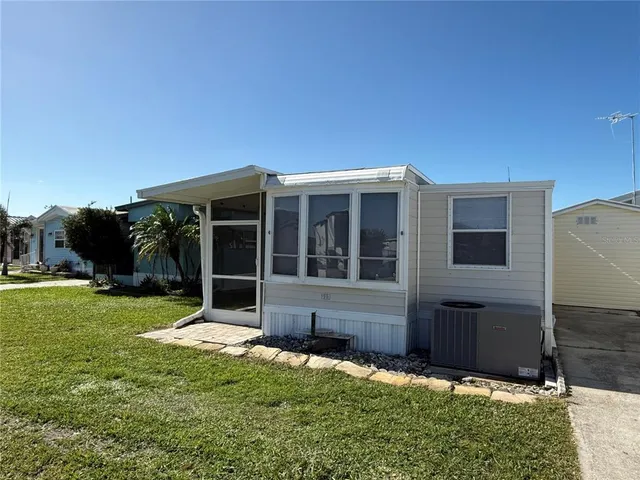a view of house with backyard
