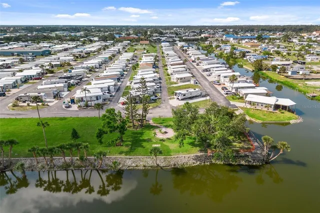 an aerial view of residential houses with outdoor space and swimming pool