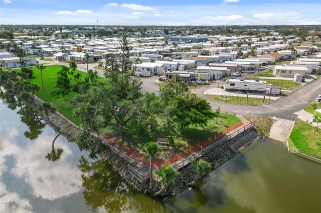an aerial view of a house with a yard and lake view
