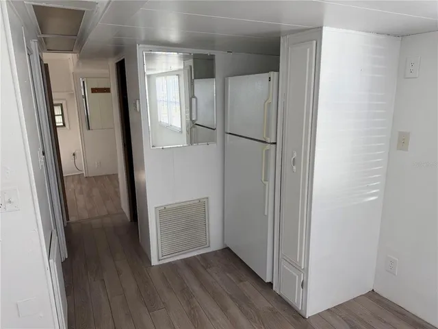 a view of hallway with wooden floor