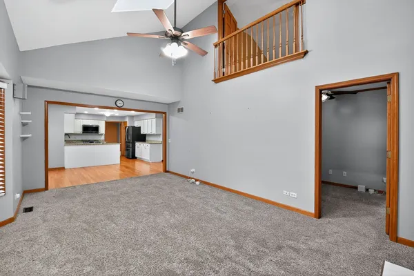 an empty room with an empty space and a kitchen space