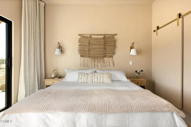 a bathroom with a granite countertop sink toilet and mirror