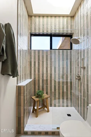 a bedroom with a large bed and a large window