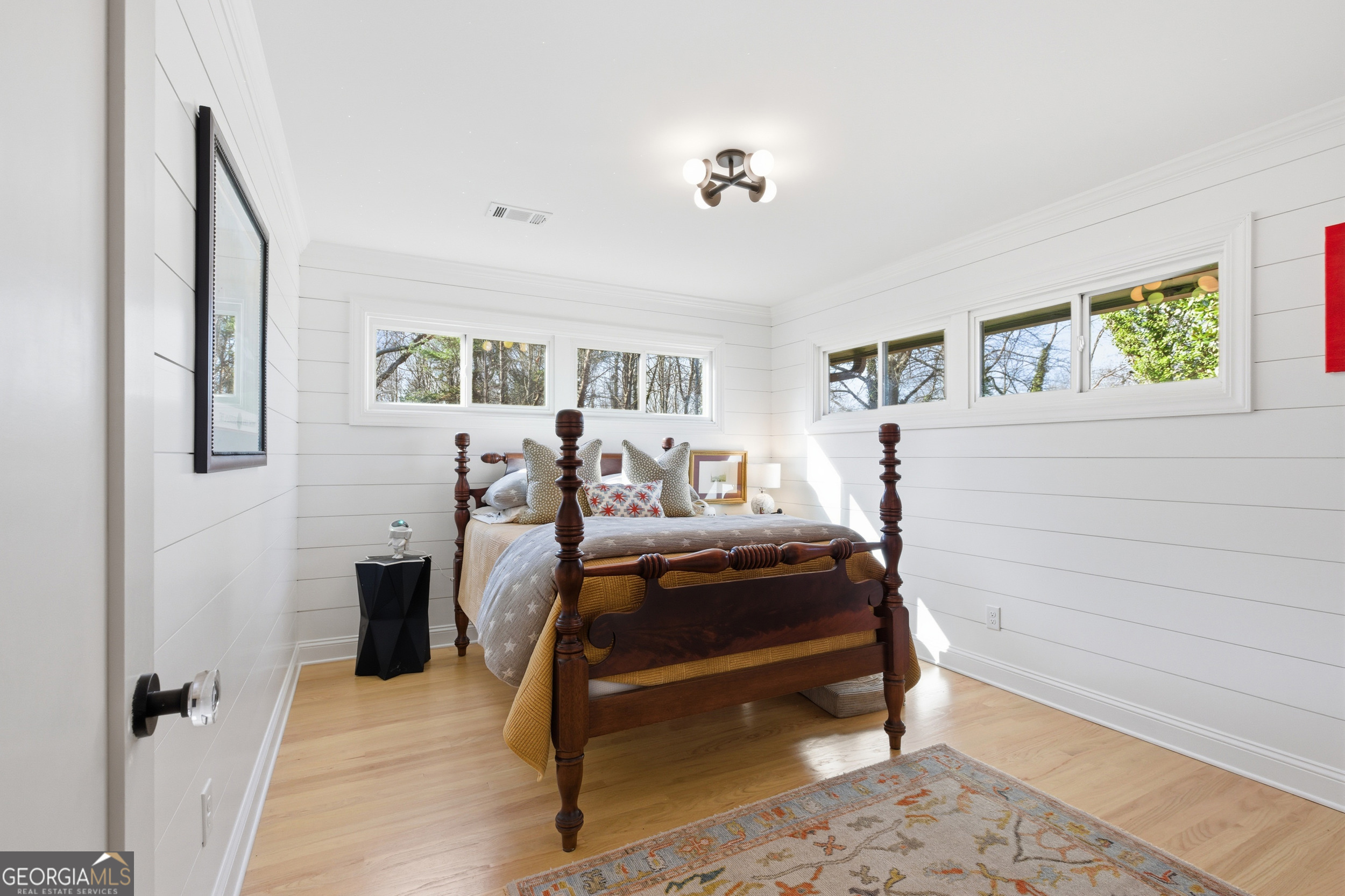 125 Maple Street Cornelia, GA 30531 - Photo 31 of 44 a bedroom with a bed and wooden floor