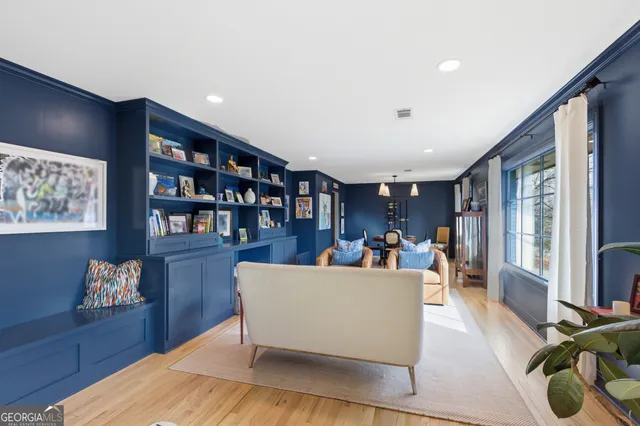 a living room with furniture and a book shelf