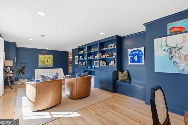 a living room with furniture and painting on the wall