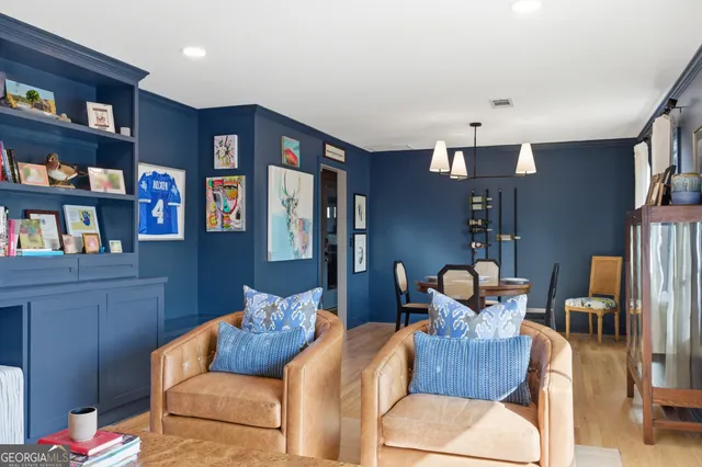 a living room with furniture and a book shelf