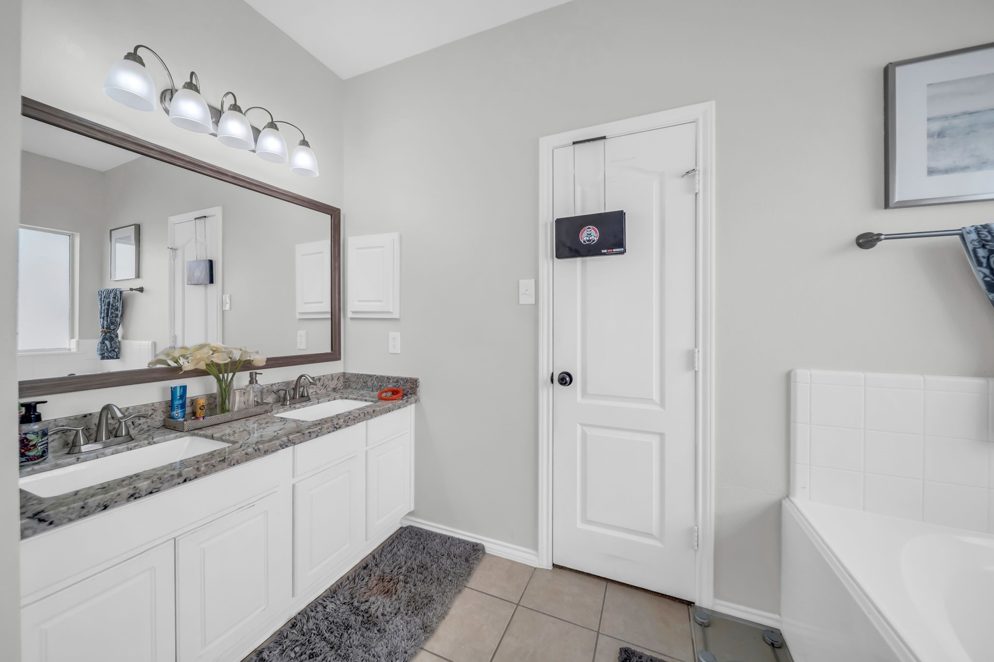 4502 Baron Road Baytown, TX 77521 - Photo 16 of 25 a bathroom with a granite countertop sink and a mirror