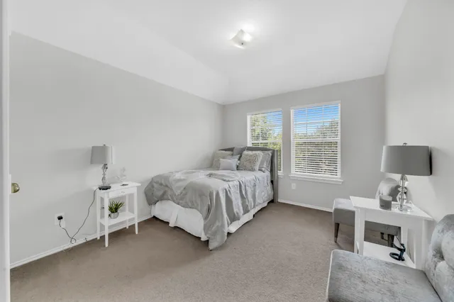 a bed room with a bed and a window