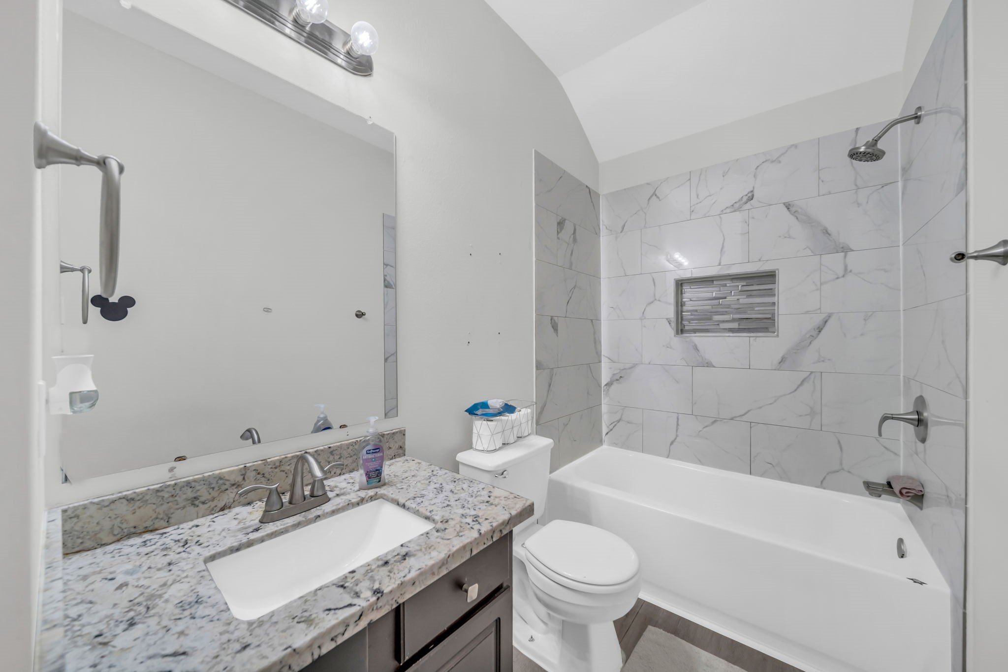 4502 Baron Road Baytown, TX 77521 - Photo 20 of 25 a bathroom with a granite countertop sink mirror toilet and bathtub